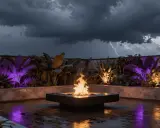 Terrasse tropicale illuminée de lumières violettes et oranges, avec un brasero crépitant sous un ciel d'orage. Le culot ampoule G4 éclaire subtilement les plantes exotiques.