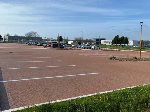 Parking extérieur avec revêtement de sol en gravier coloré, une solution pas chère pour revêtement sol parking voiture en extérieur.