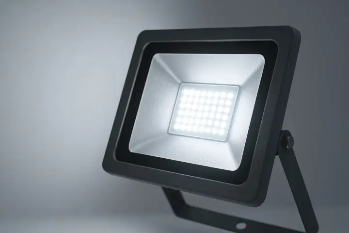 Projecteur LED extérieur noir avec une grille de diodes lumineuses blanches.
